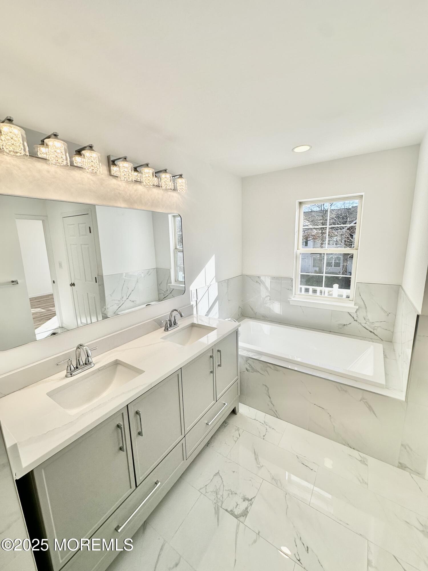 51 Picket Place Freehold, NJ 07728 - Photo 35 of 47 a bathroom with a tub sink and mirror
