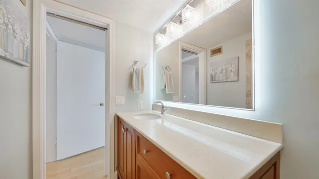 a living room with furniture and a large window with wooden floor