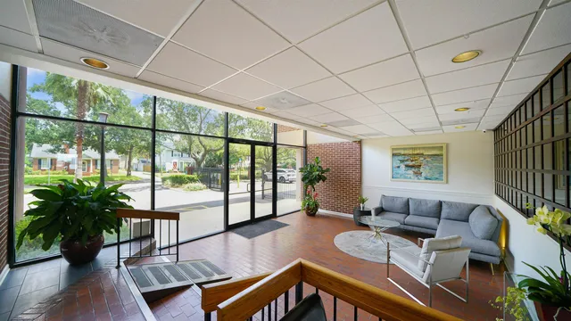 a view of a hallway with wooden floor and windows