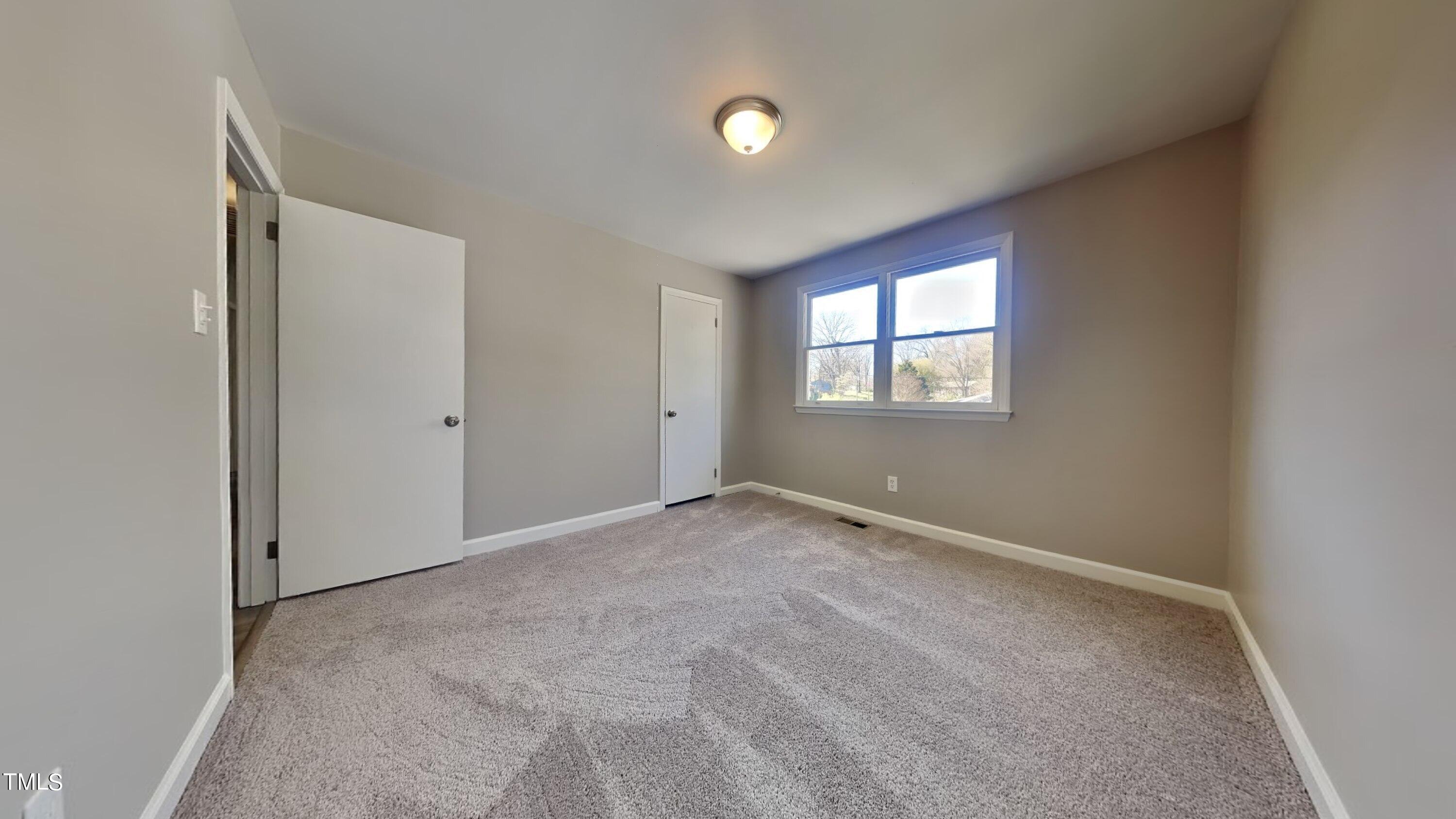 2028 Timber Drive Raleigh, NC 27604 - Photo 7 of 13 an empty room with windows and closet