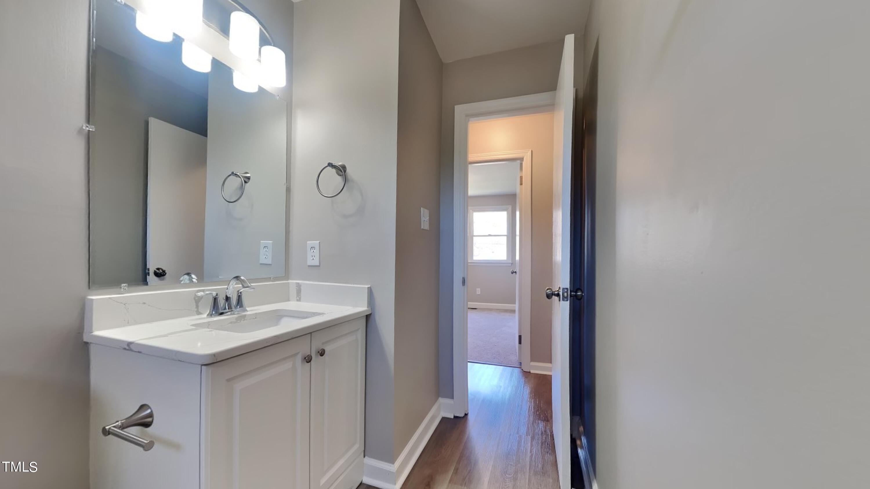 2028 Timber Drive Raleigh, NC 27604 - Photo 9 of 13 a bathroom with a sink vanity and a mirror