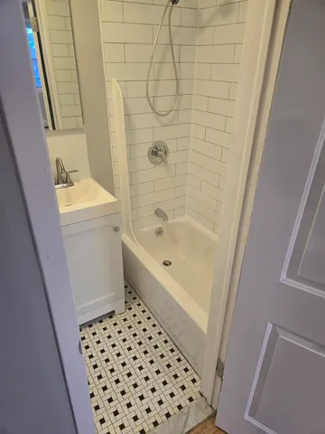 a bathroom with a bathtub and a sink