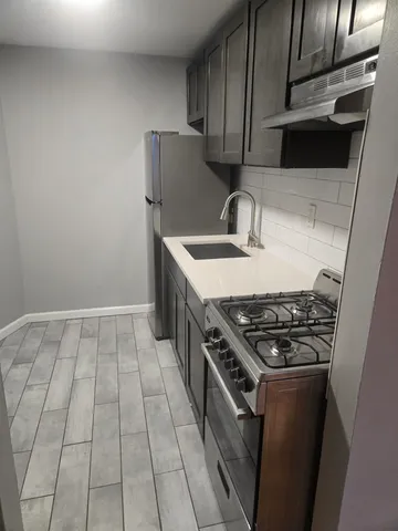 a kitchen with granite countertop a stove and a sink