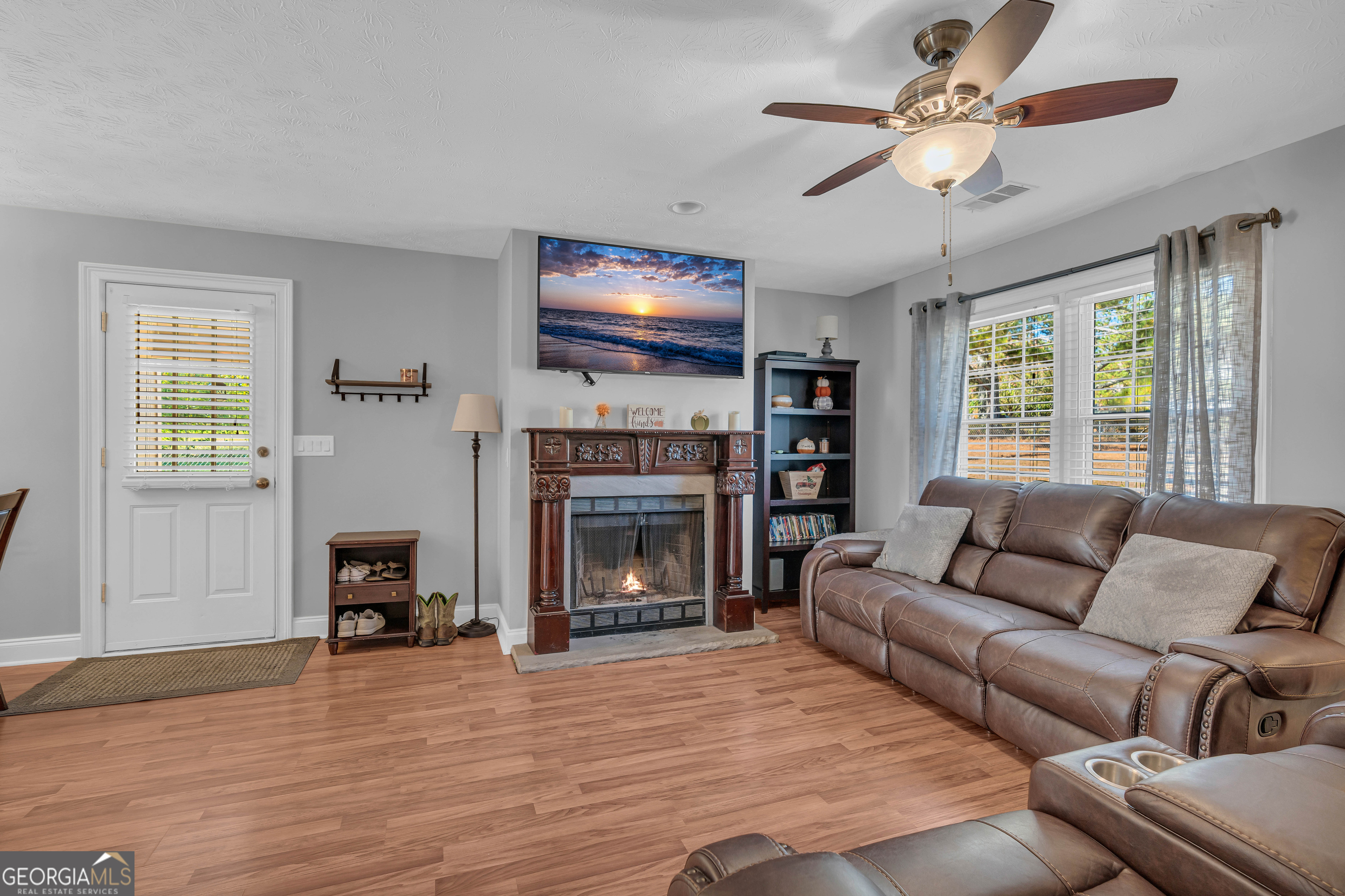 809 Parker Court Monroe, GA 30656 - Photo 12 of 55 a living room with furniture a fireplace and a flat screen tv