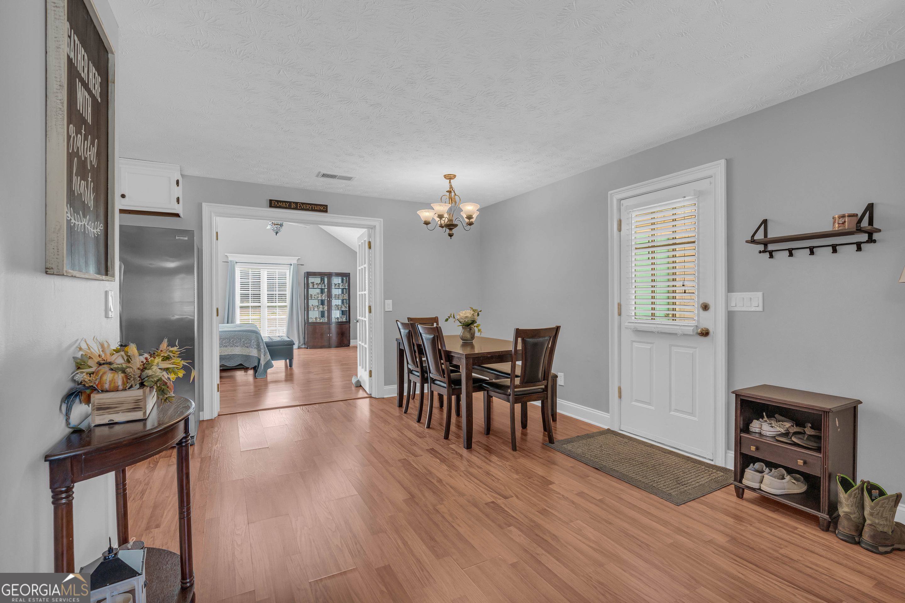 809 Parker Court Monroe, GA 30656 - Photo 14 of 55 a view of a dining room with furniture and wooden floor