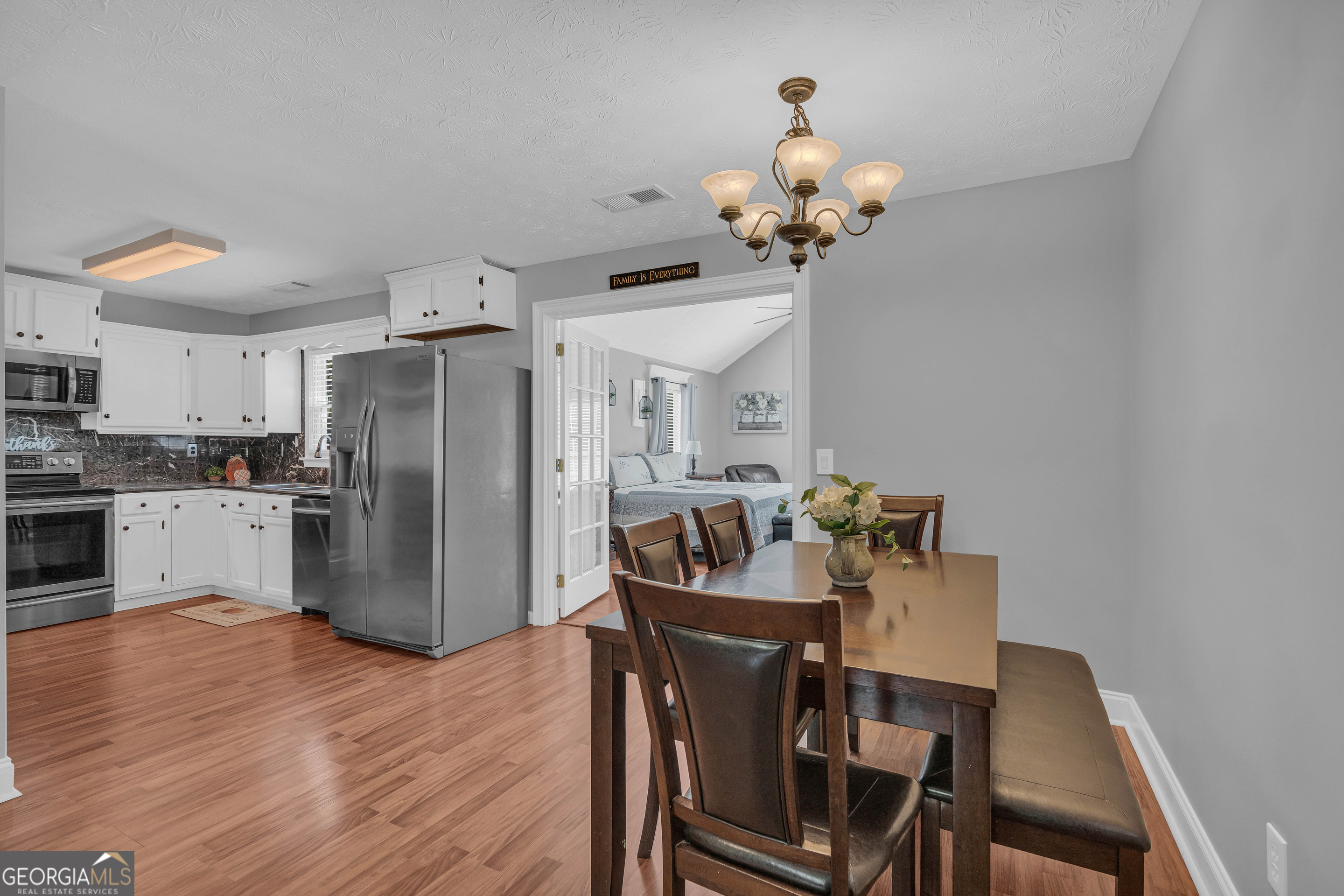 809 Parker Court Monroe, GA 30656 - Photo 22 of 55 a kitchen with refrigerator dining table and chairs