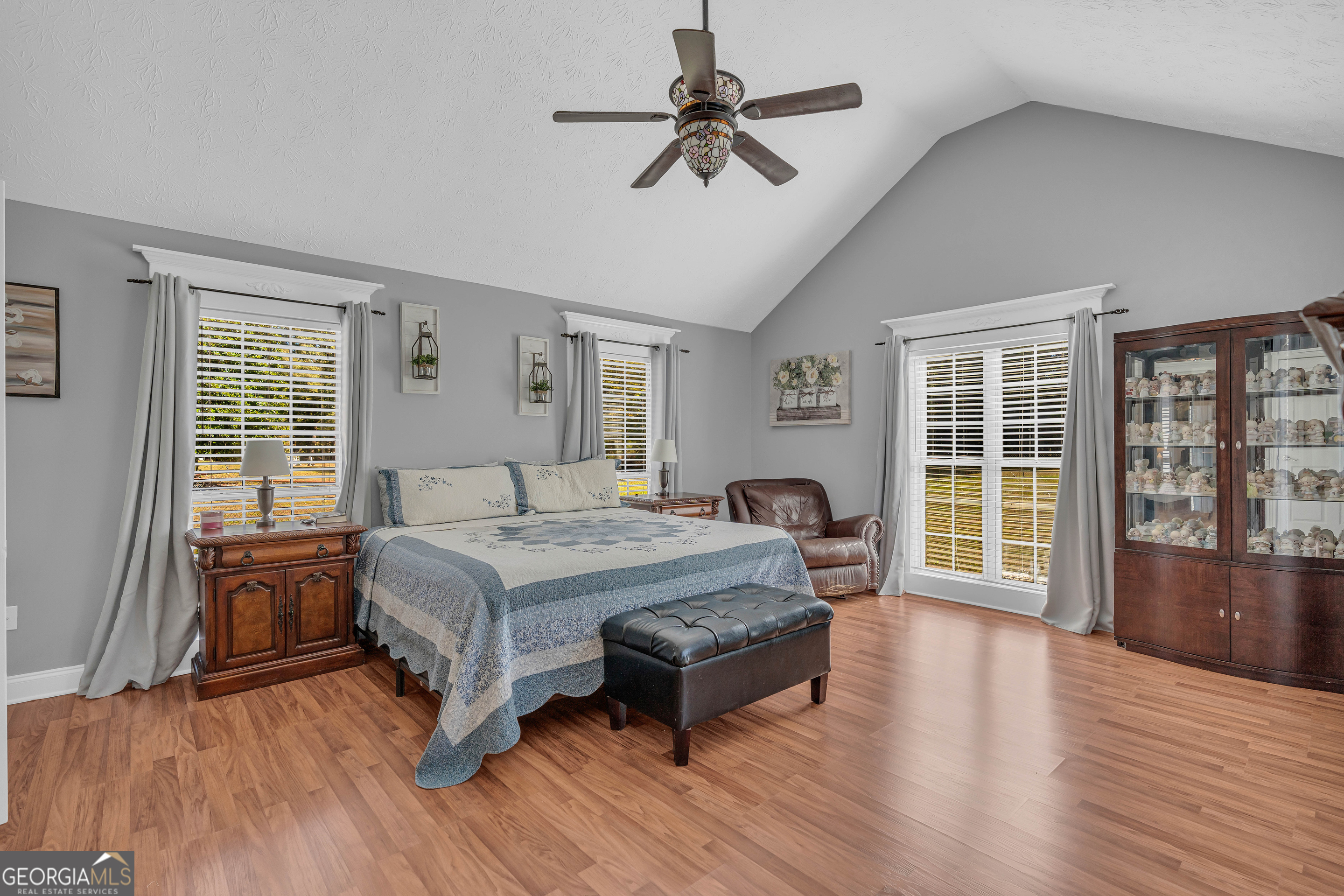 809 Parker Court Monroe, GA 30656 - Photo 24 of 55 a spacious bedroom with a bed a dresser and wooden floor