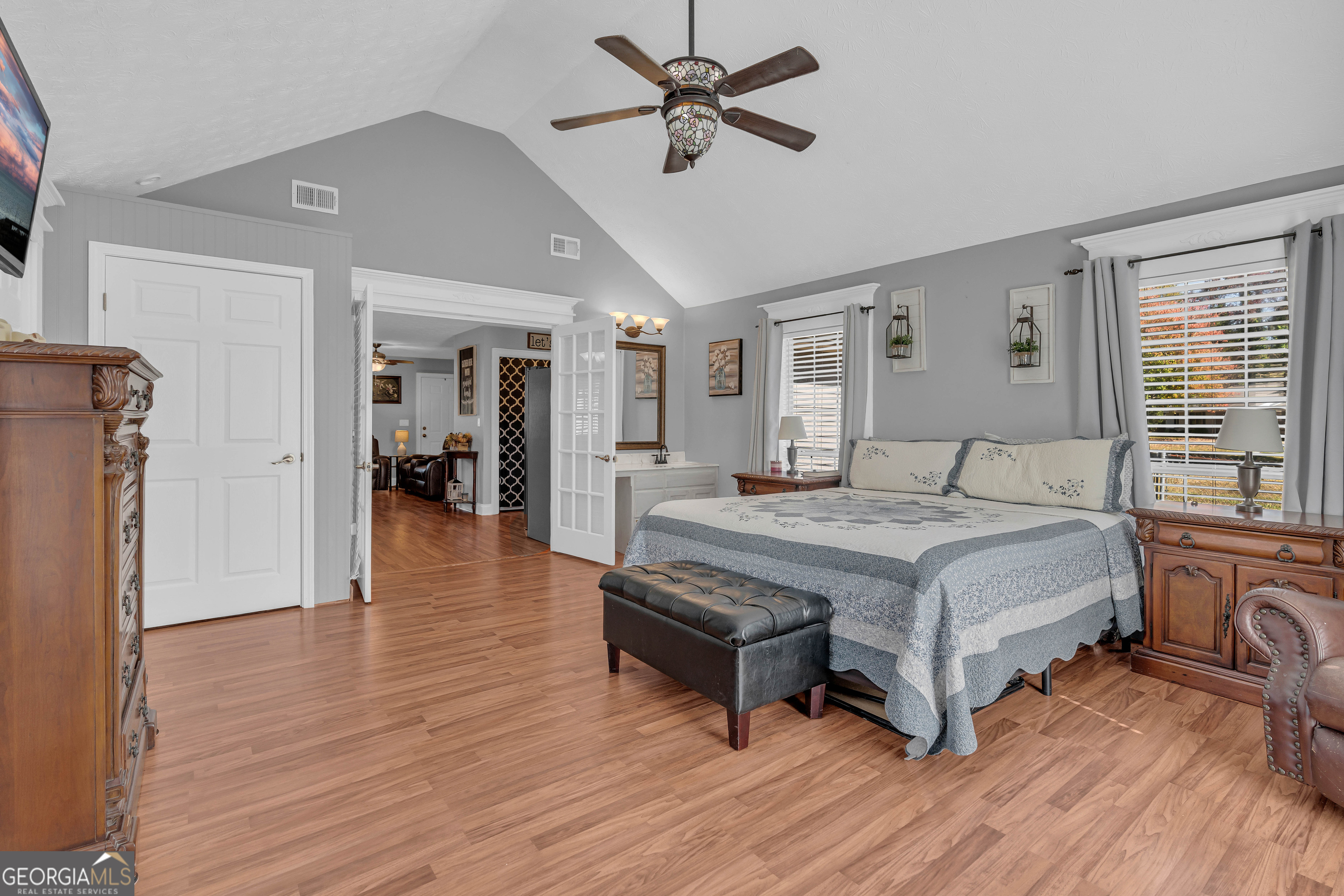 809 Parker Court Monroe, GA 30656 - Photo 26 of 55 a spacious bedroom with a bed and a chandelier