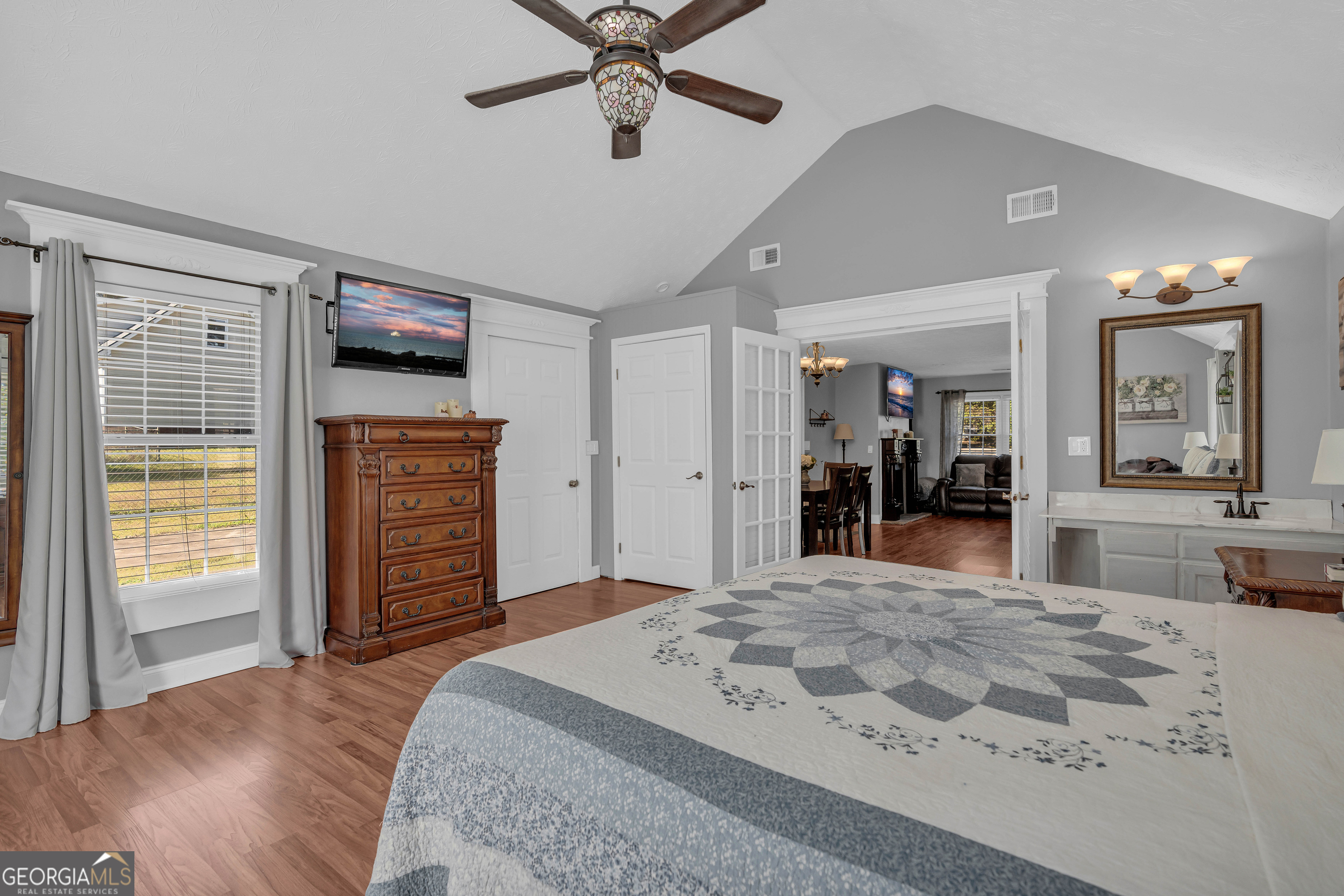 809 Parker Court Monroe, GA 30656 - Photo 27 of 55 a spacious bedroom with a bed and a dresser with mirror