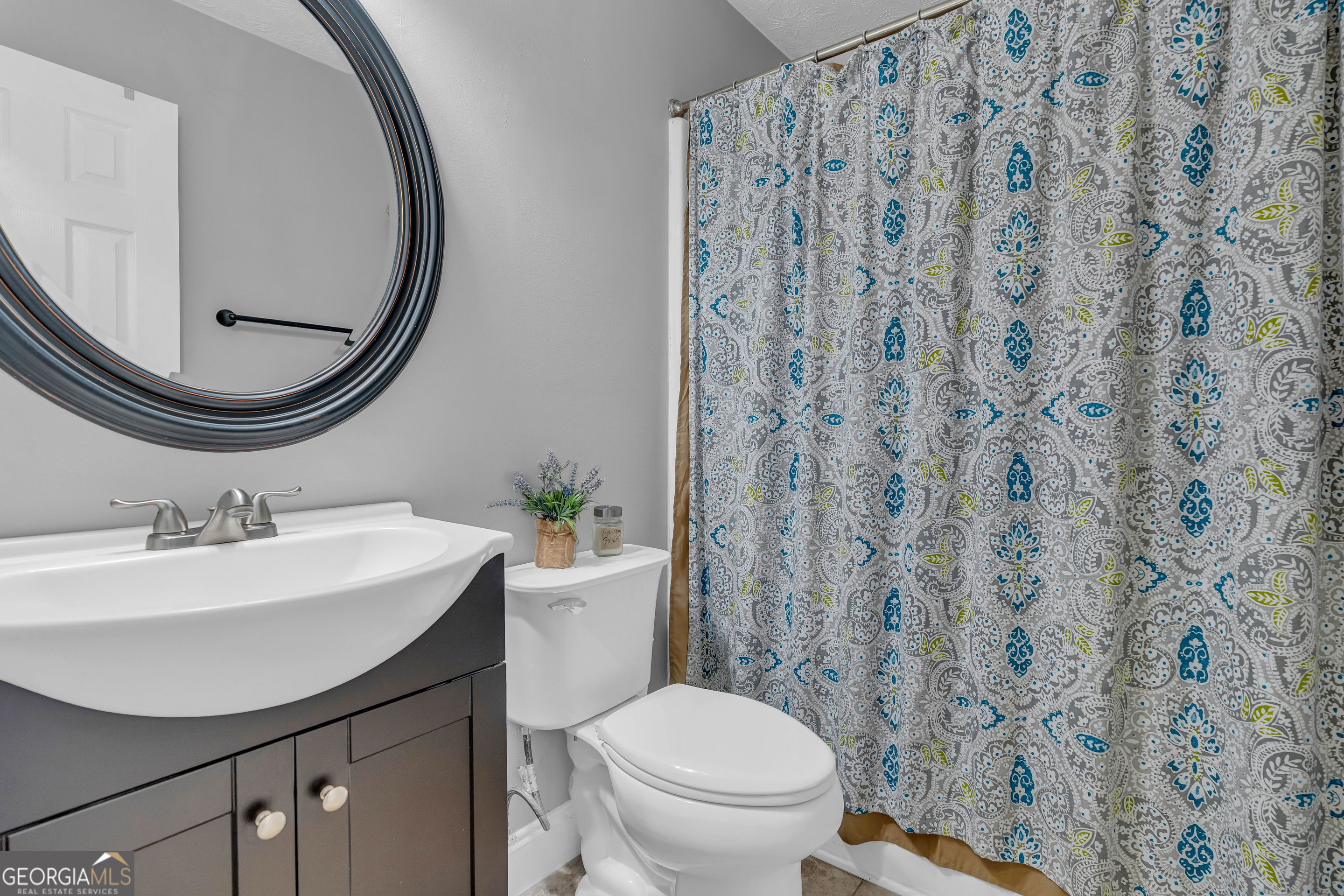 809 Parker Court Monroe, GA 30656 - Photo 28 of 55 a bathroom with a sink a toilet and a mirror