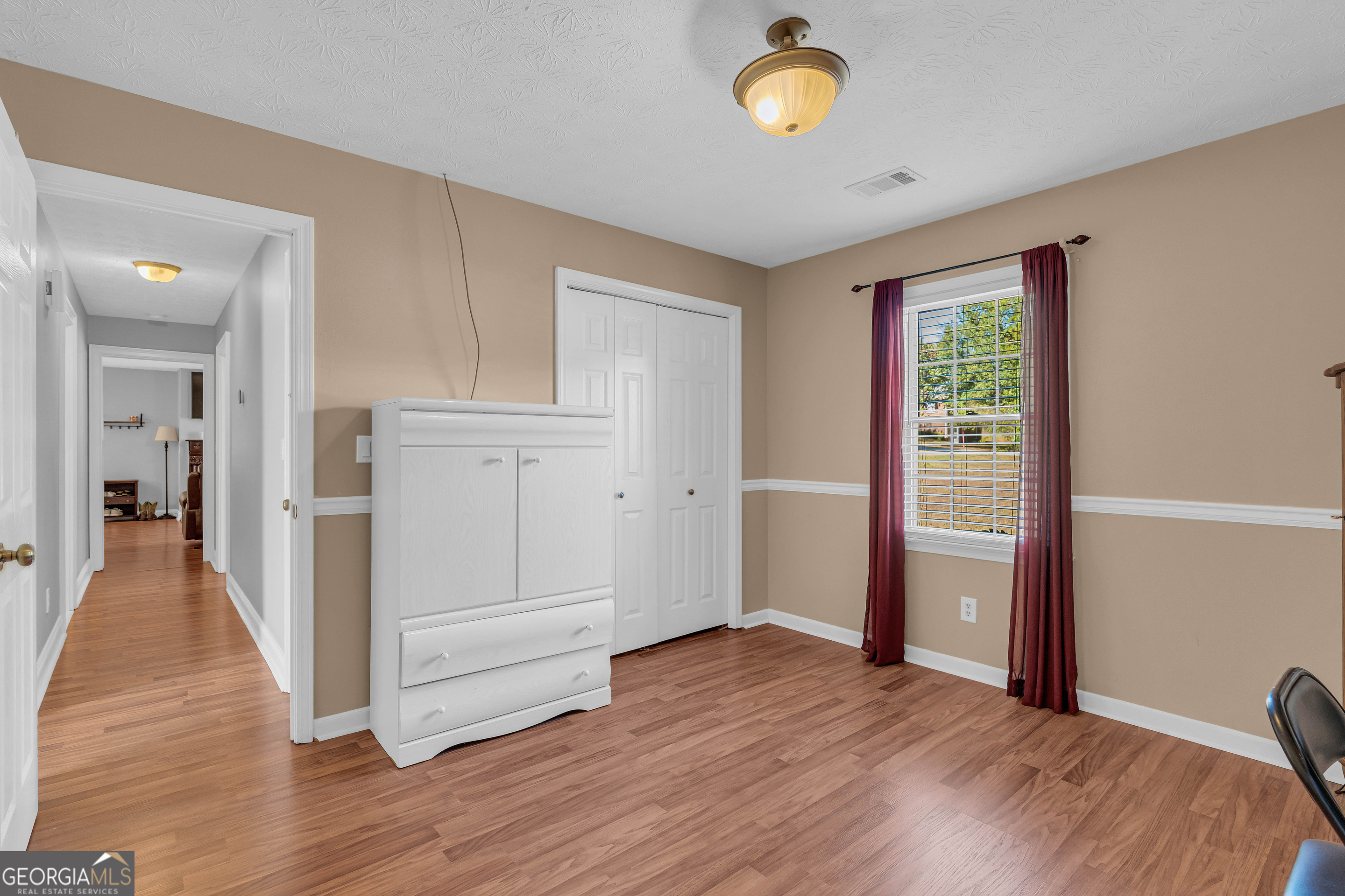 809 Parker Court Monroe, GA 30656 - Photo 32 of 55 wooden floor in an empty room with a window