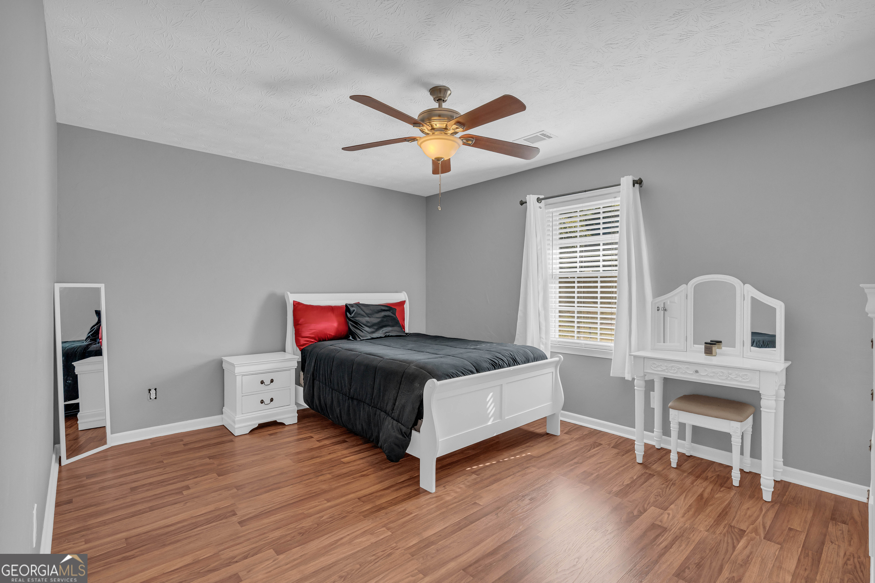 809 Parker Court Monroe, GA 30656 - Photo 33 of 55 a bedroom with a bed and wooden floor