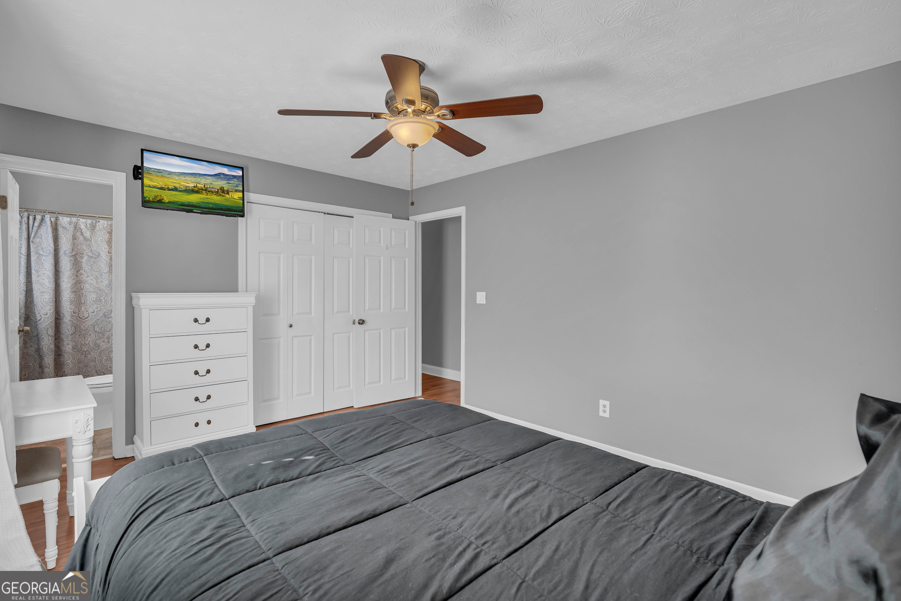 809 Parker Court Monroe, GA 30656 - Photo 35 of 55 a bedroom with a bed and a ceiling fan