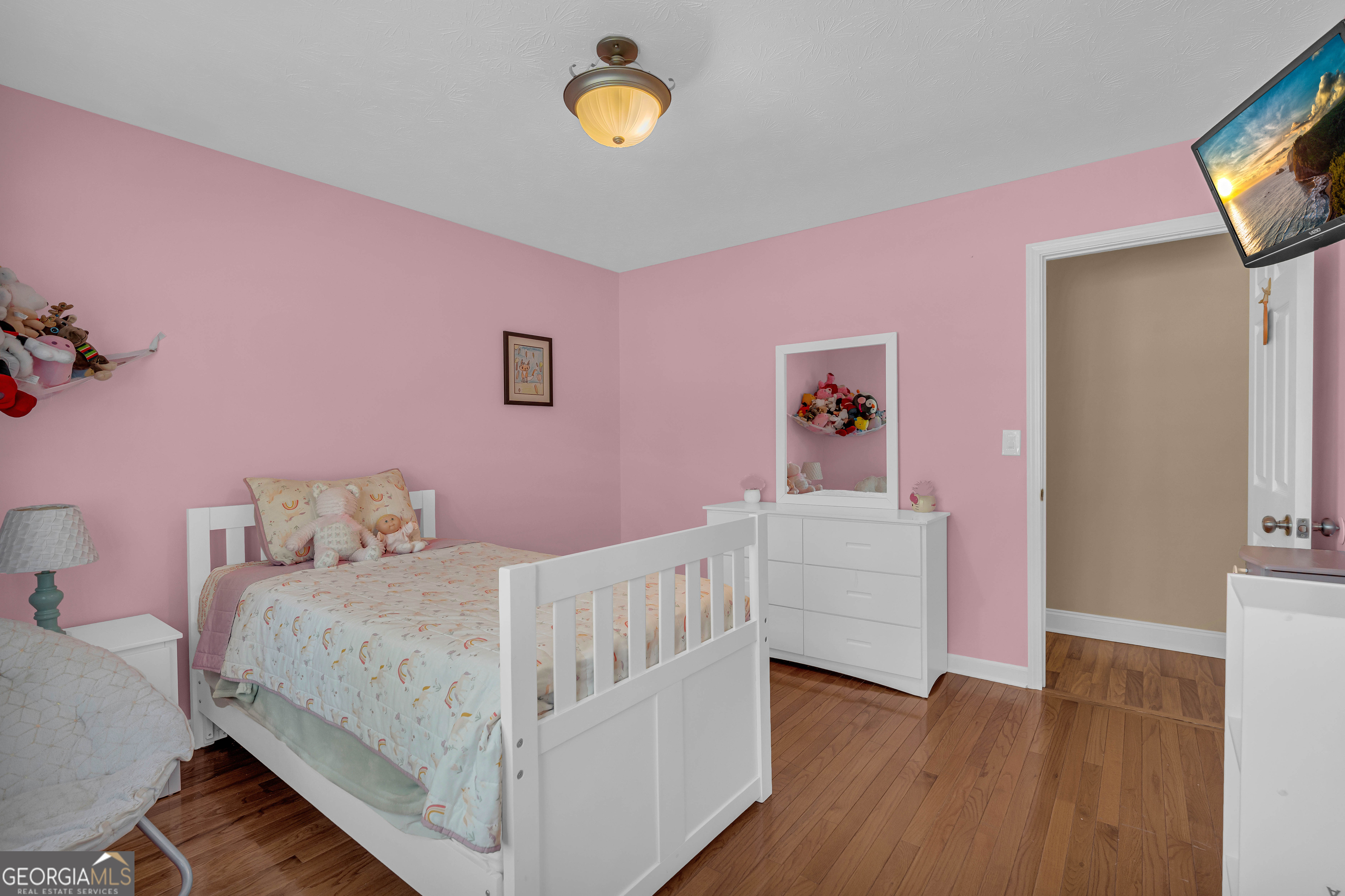 809 Parker Court Monroe, GA 30656 - Photo 39 of 55 a bedroom with a bed and a flat screen tv