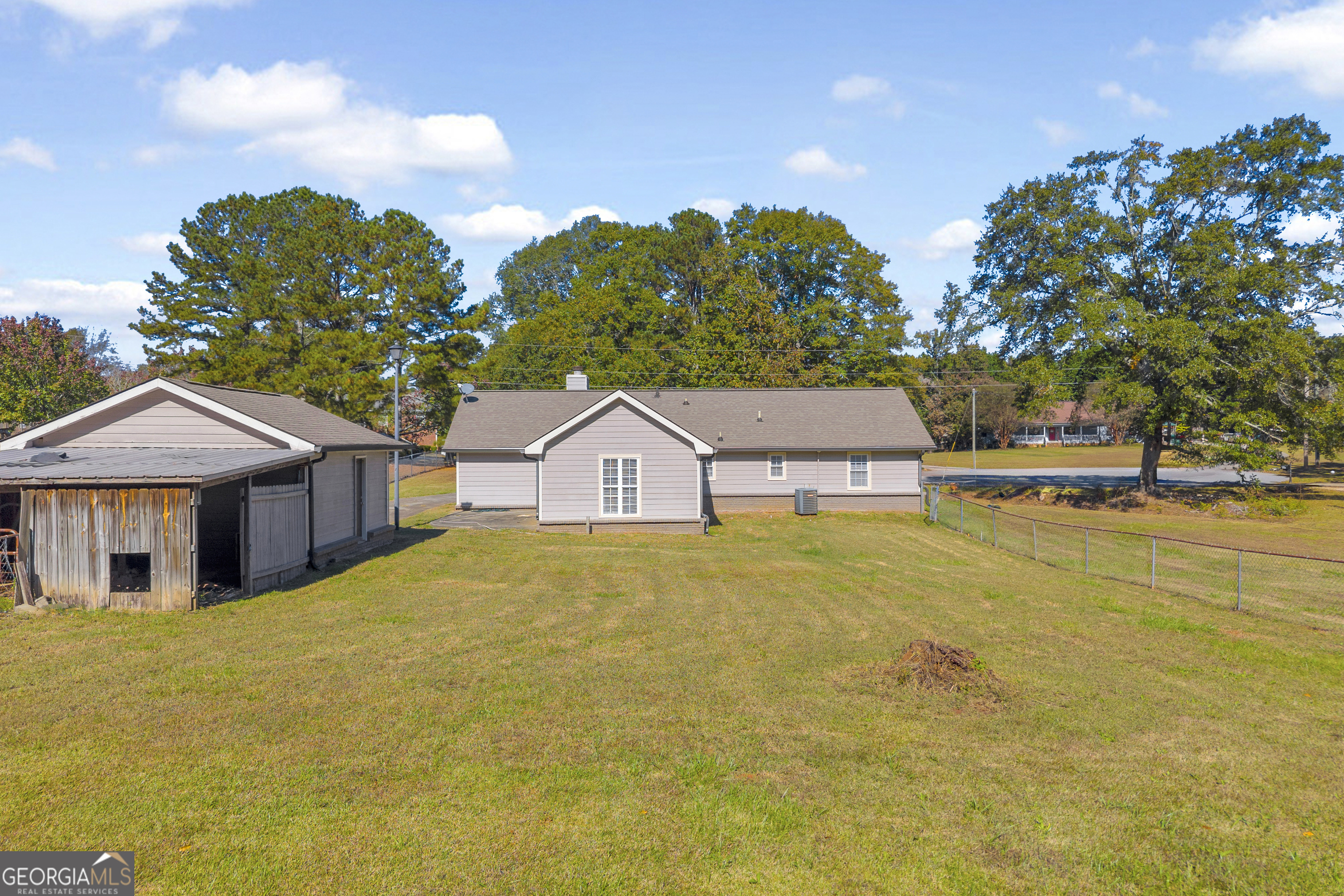 809 Parker Court Monroe, GA 30656 - Photo 42 of 55 a front view of a house with a yard and large trees
