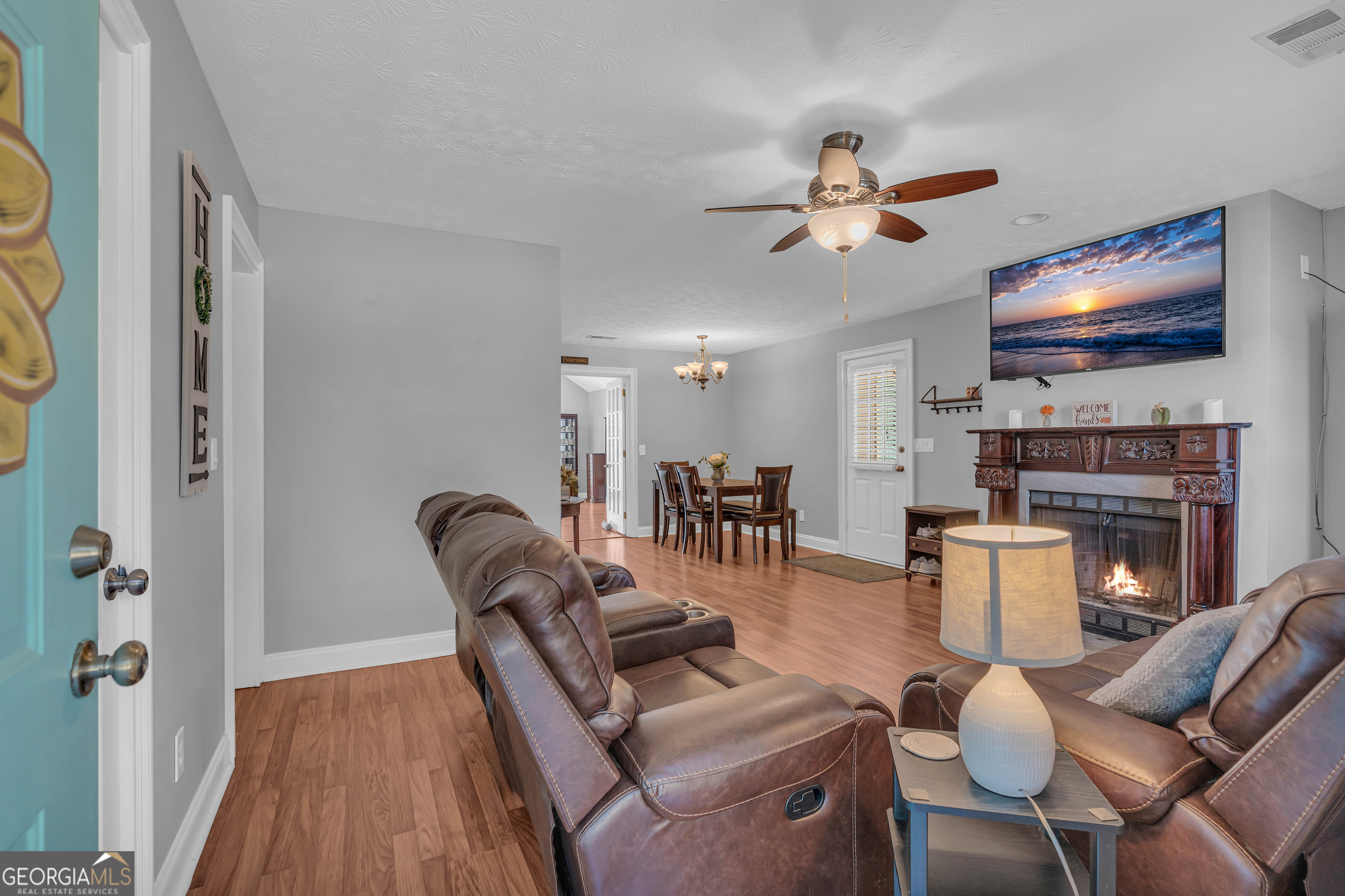 809 Parker Court Monroe, GA 30656 - Photo 8 of 55 a living room with furniture a fireplace and a flat screen tv