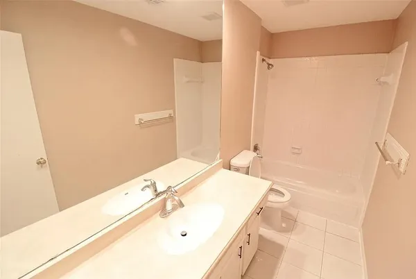 a bathroom with a tub sink and a mirror