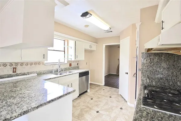 a bathroom with a granite countertop sink a bathtub and a shower