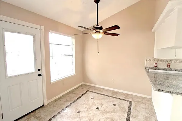 a view of a kitchen with wooden floor and a window