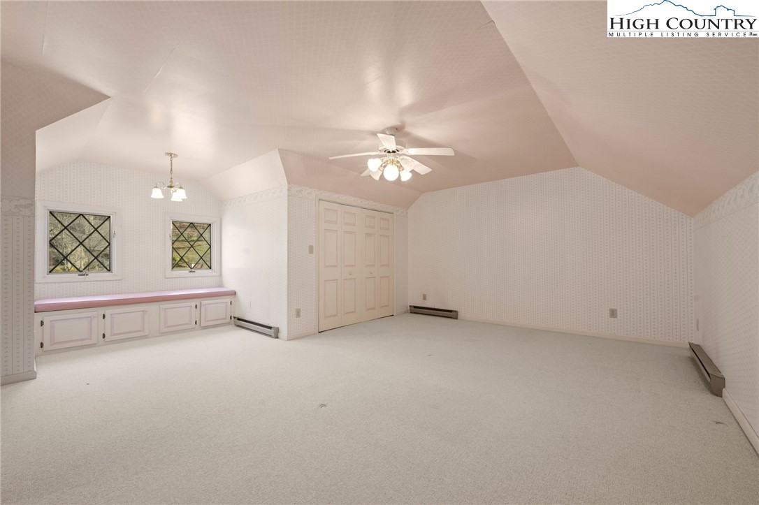 304 Glendale Drive Boone, NC 28607 - Photo 41 of 50 an empty room with windows and ceiling fan