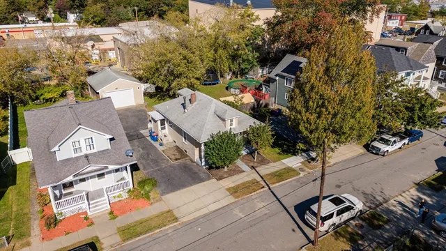 an aerial view of multiple houses with yard