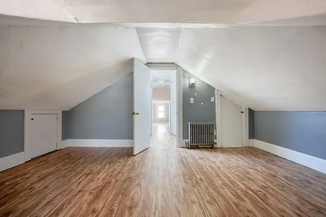 a view of a big room with wooden floor and windows