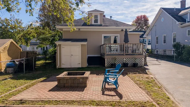 a view of a house with backyard and sitting area