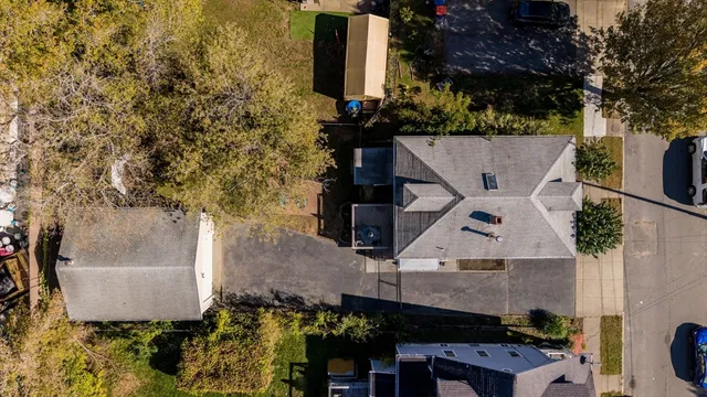 an aerial view of a house with a yard