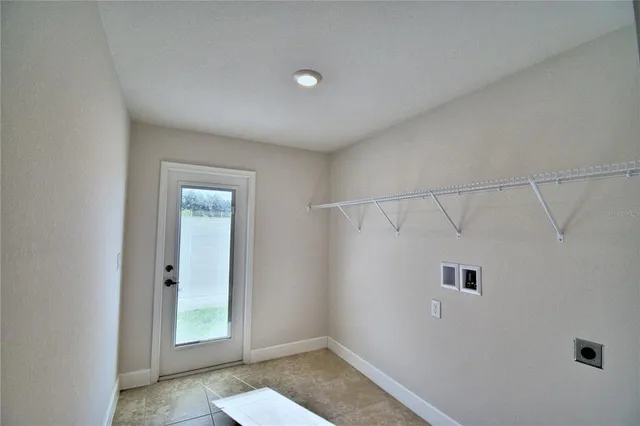 a kitchen with granite countertop white cabinets and a sink