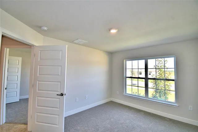 a bathroom with a tub a sink and a window