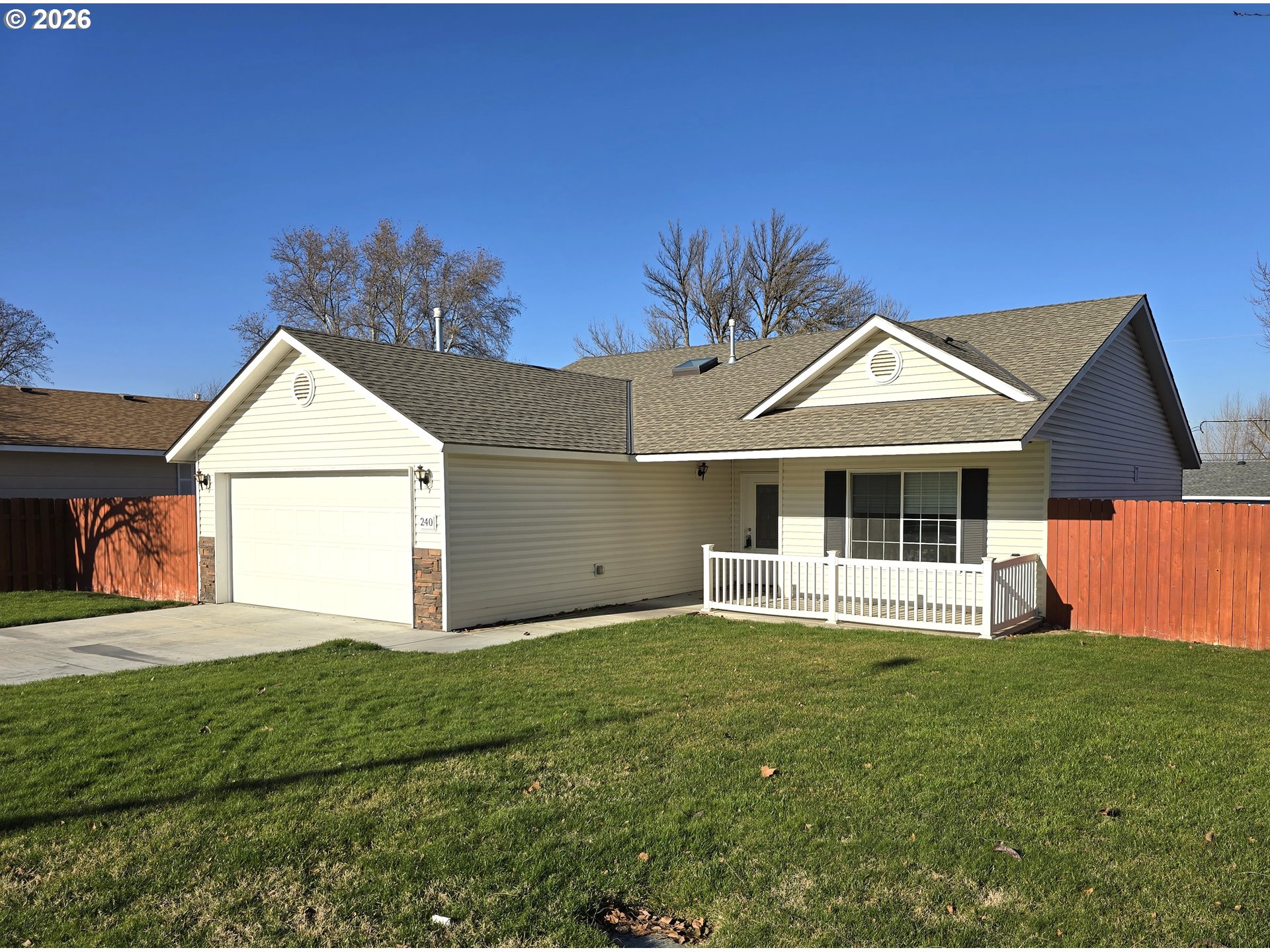 240 West Moore Avenue Hermiston, OR 97838 - Photo 1 of 19 a front view of a house with a yard and garage