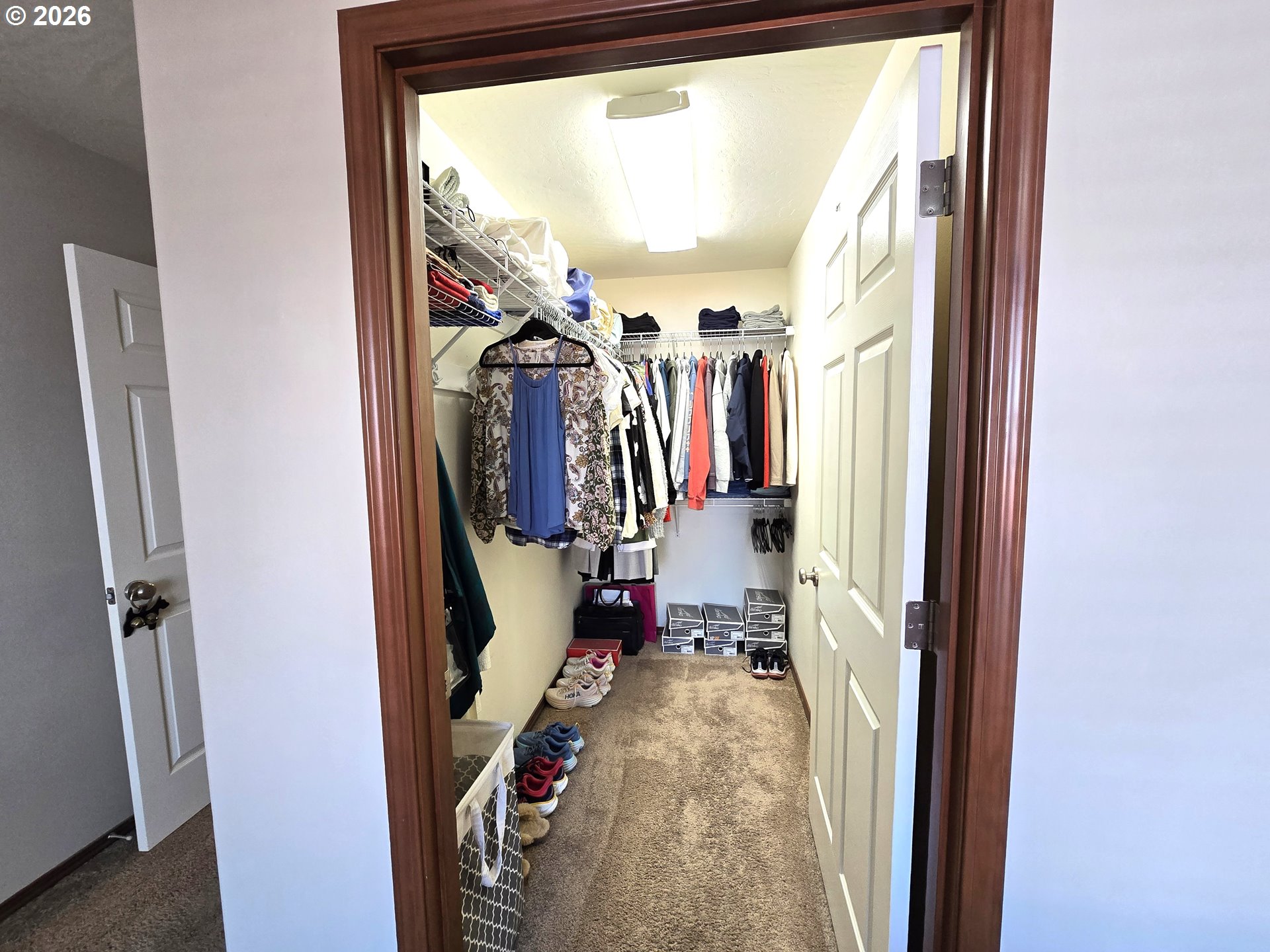 240 West Moore Avenue Hermiston, OR 97838 - Photo 11 of 19 a view of walk in closet with clothes and shoes