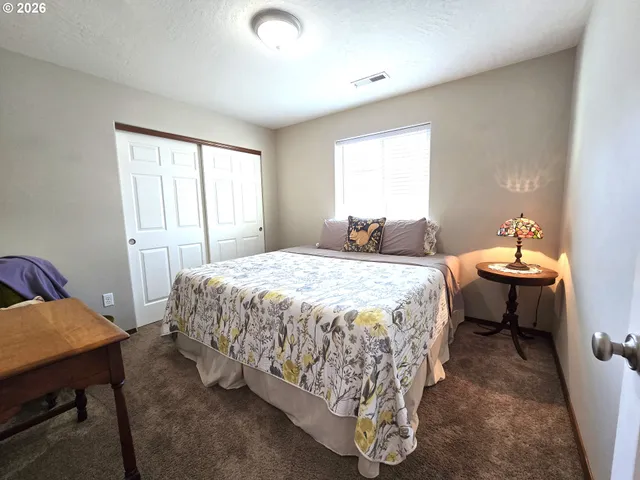 a bedroom with a bed and a table