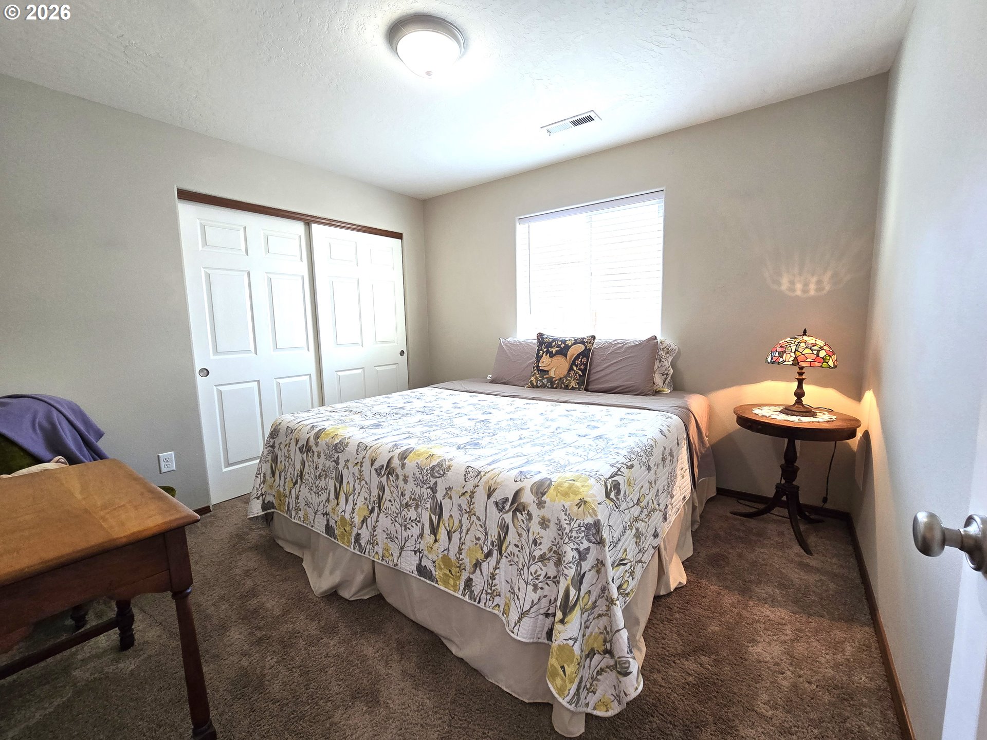 240 West Moore Avenue Hermiston, OR 97838 - Photo 13 of 19 a bedroom with a bed and a table