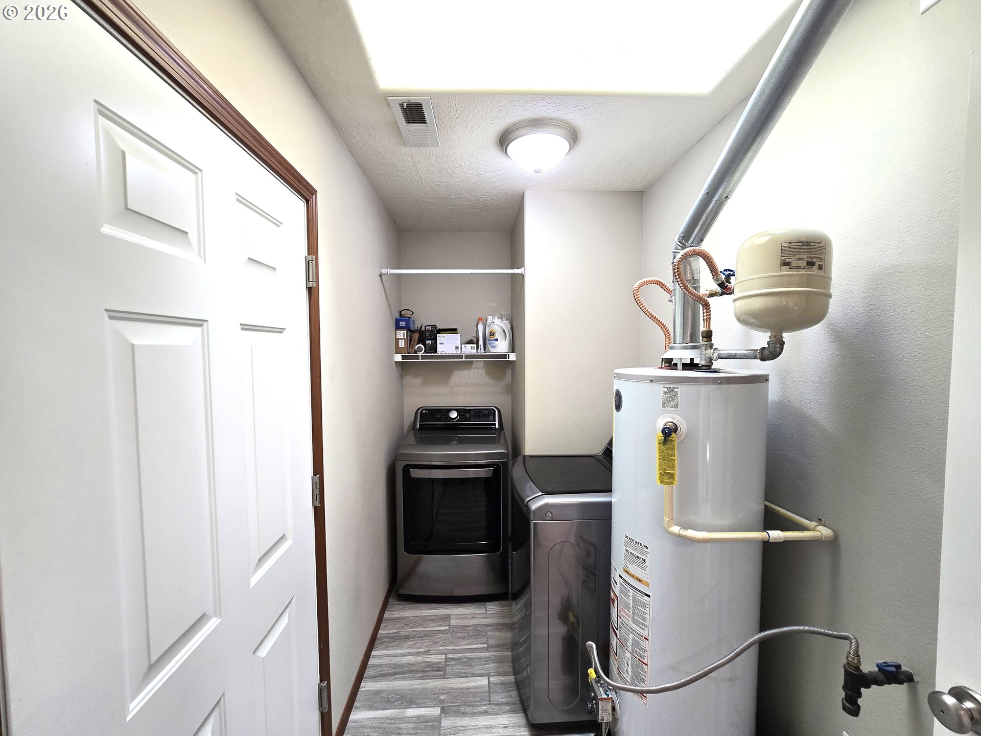 240 West Moore Avenue Hermiston, OR 97838 - Photo 15 of 19 a kitchen with a refrigerator and cabinets