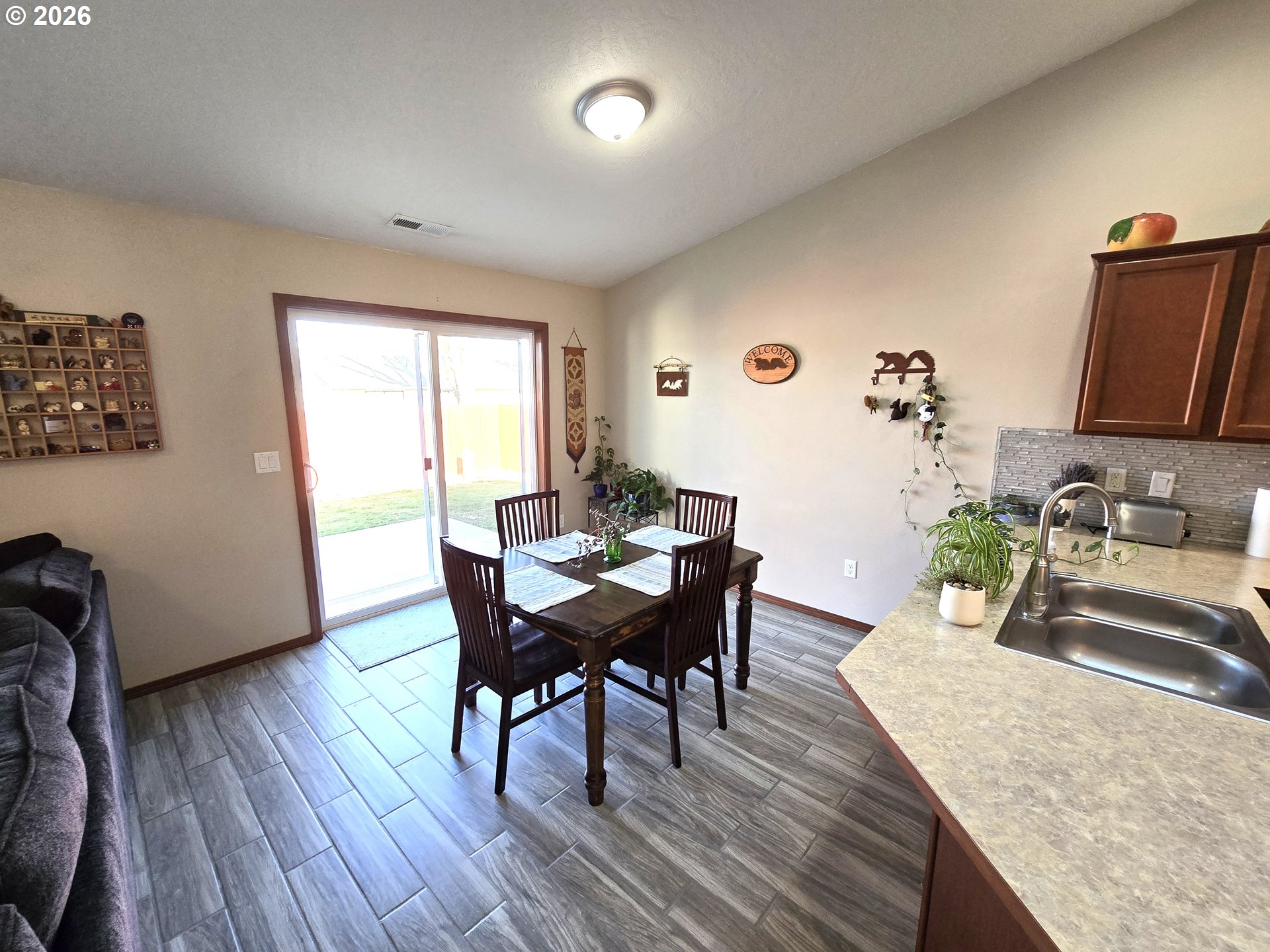 240 West Moore Avenue Hermiston, OR 97838 - Photo 4 of 19 a view of a dining room with furniture and wooden floor