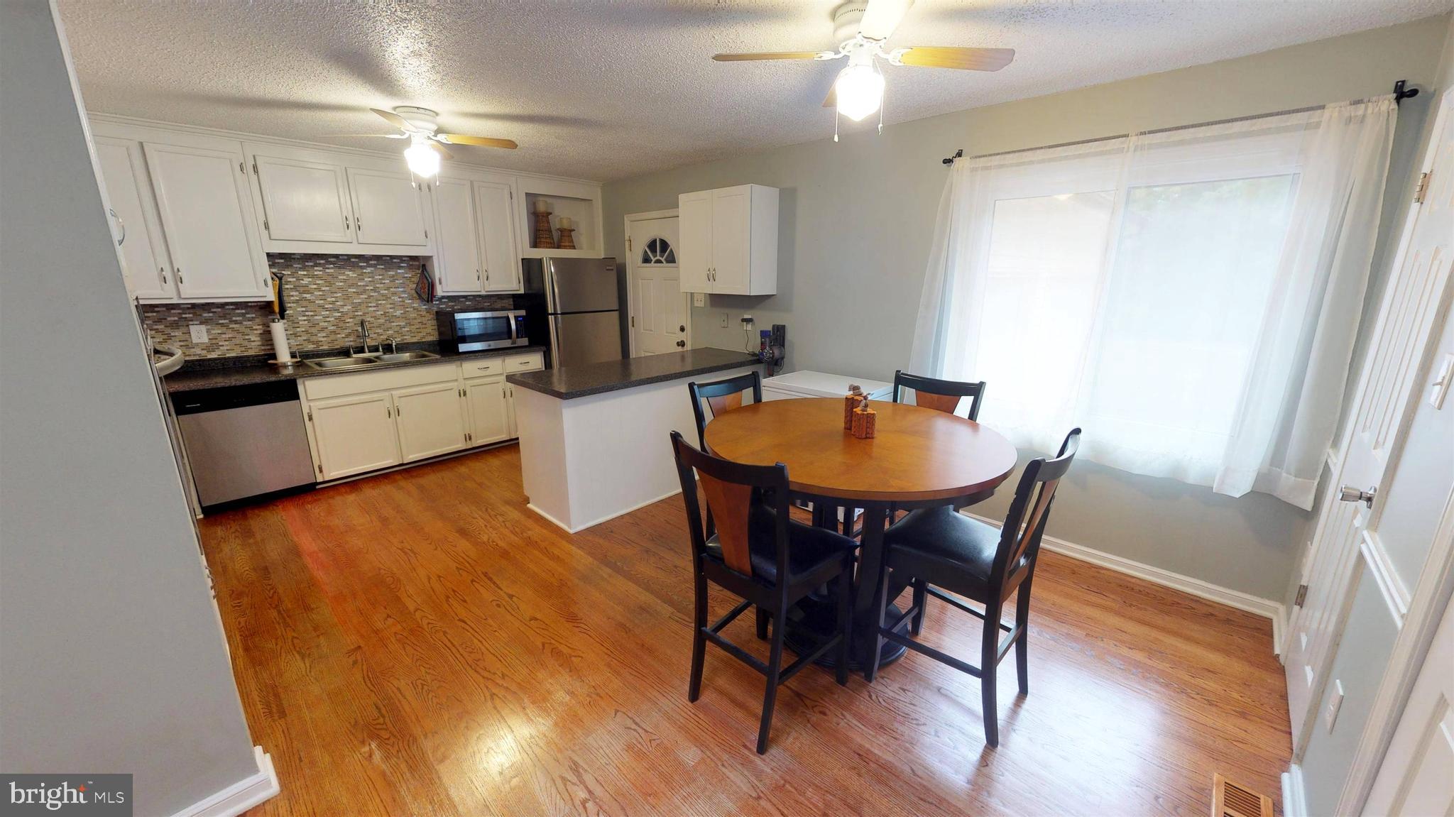 919 Swan Lane Ruther Glen, VA 22546 - Photo 9 of 30 Kitchen/Dining Room with Hardwood Floors
