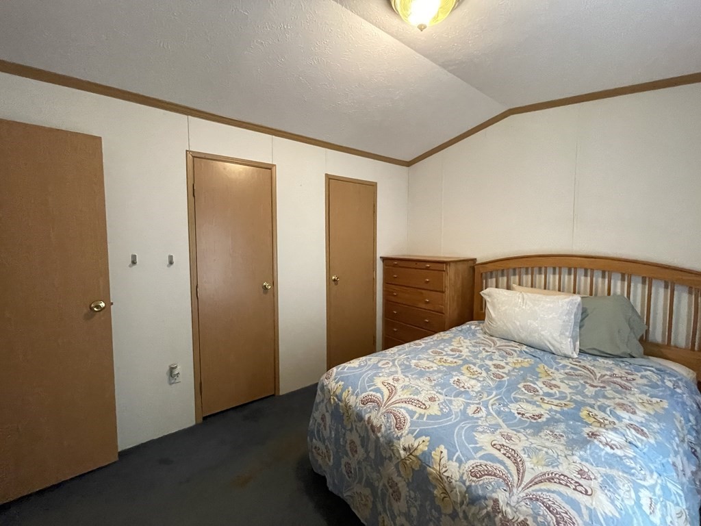 268 Palmer Road, Unit 12 Monson, MA 01057 - Photo 11 of 15 a bedroom with a large bed and a potted plant