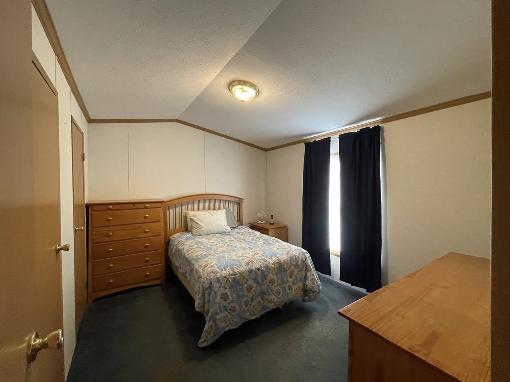 268 Palmer Road, Unit 12 Monson, MA 01057 - Photo 12 of 15 a bedroom with a bed and a dresser