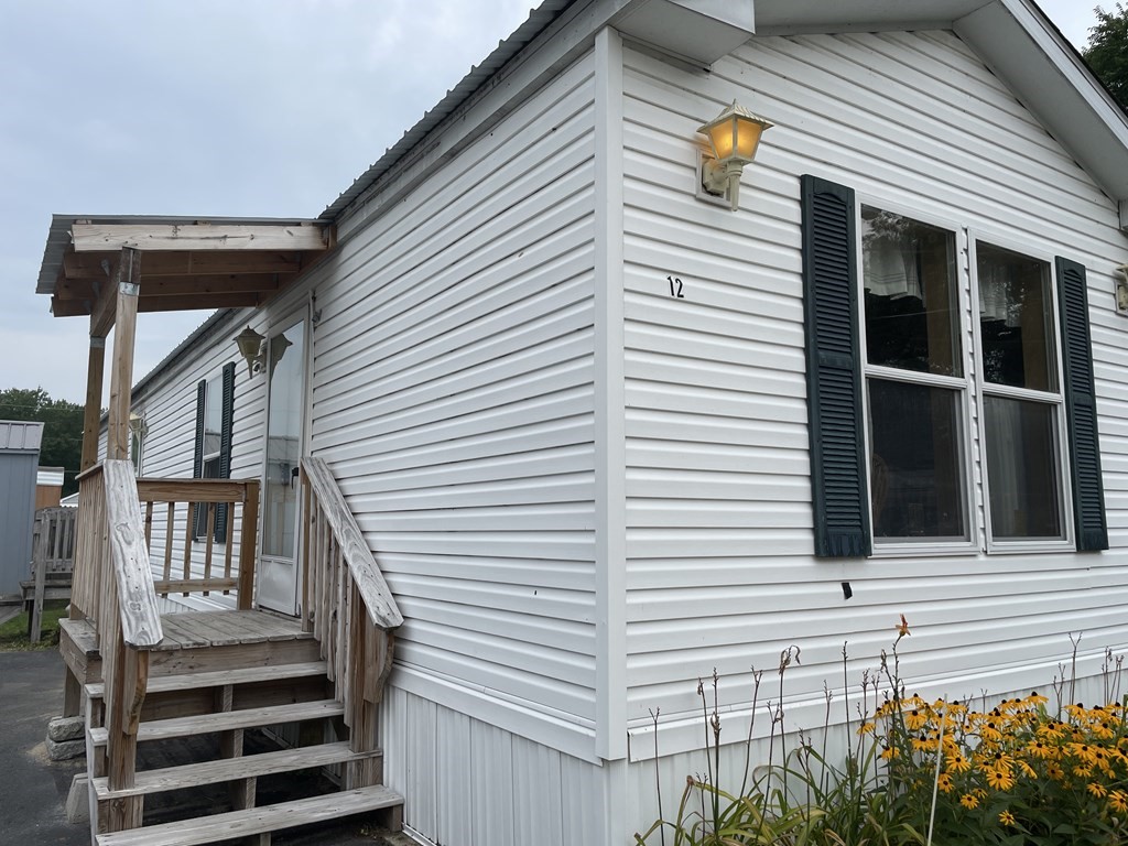 268 Palmer Road, Unit 12 Monson, MA 01057 - Photo 2 of 15 a view of a house with a window and wooden fence