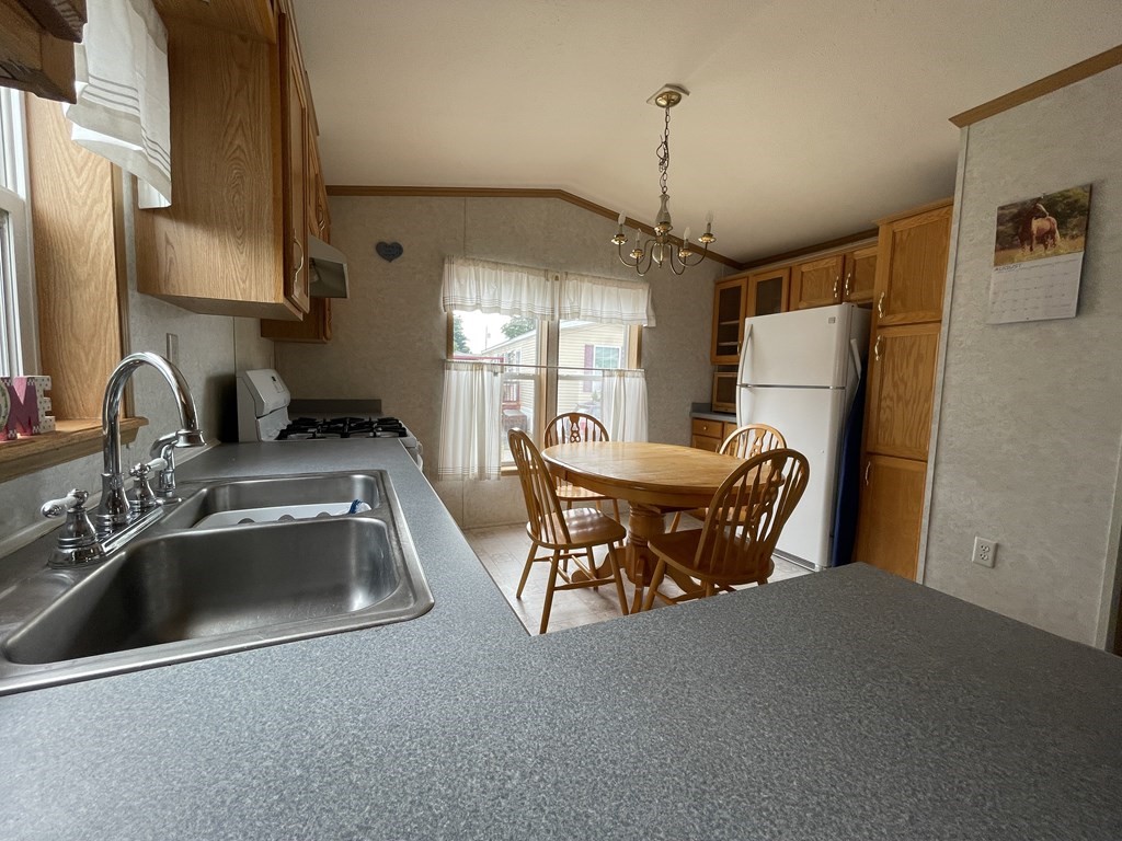 268 Palmer Road, Unit 12 Monson, MA 01057 - Photo 3 of 15 a kitchen with refrigerator a sink dishwasher a refrigerator and a sink