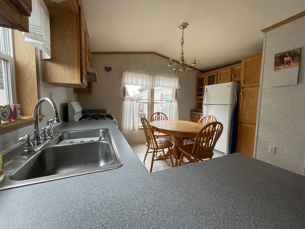 268 Palmer Road, Unit 12 Monson, MA 01057 - Photo 4 of 15 a kitchen with refrigerator a sink dishwasher a refrigerator and a sink