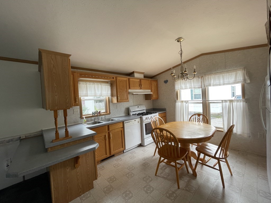 268 Palmer Road, Unit 12 Monson, MA 01057 - Photo 5 of 15 a dining room with a wooden table and chairs