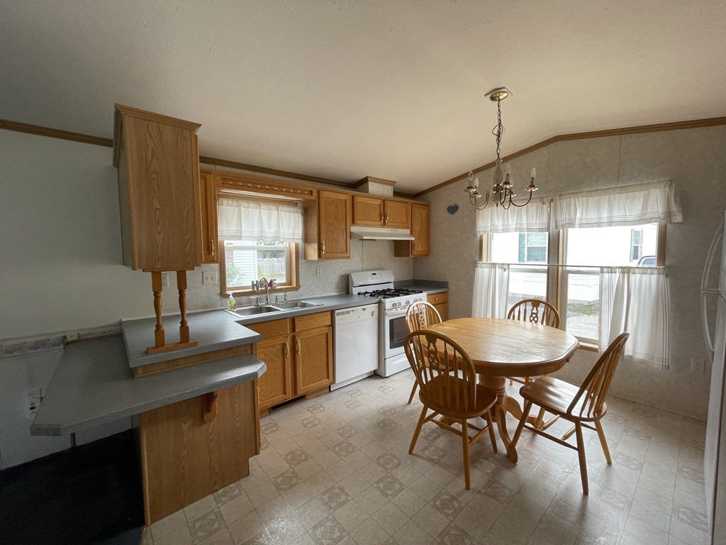 268 Palmer Road, Unit 12 Monson, MA 01057 - Photo 6 of 15 a dining hall with stainless steel appliances granite countertop a sink a stove a table and chairs