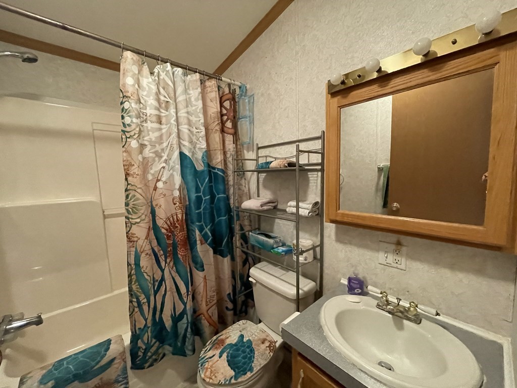 268 Palmer Road, Unit 12 Monson, MA 01057 - Photo 9 of 15 a bathroom with a sink a mirror and a shower