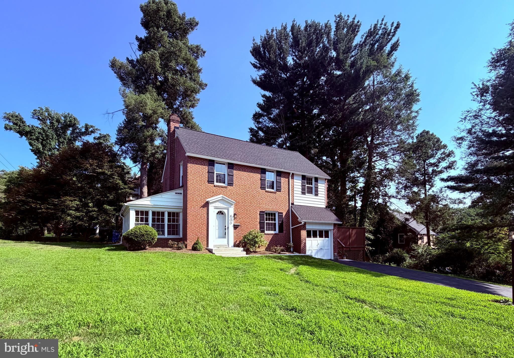 800 Pleasant Hill Road Wallingford, PA 19086 - Photo 1 of 34 a view of a yard in front of a house with plants and large tree