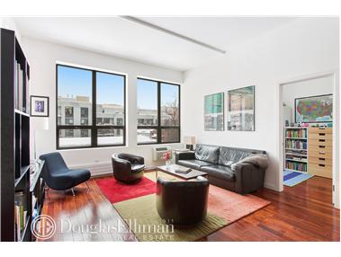 5-03 50th Avenue, Unit 3C Queens, NY 11101 - Photo 1 of 1 a living room with furniture or couch and a large window