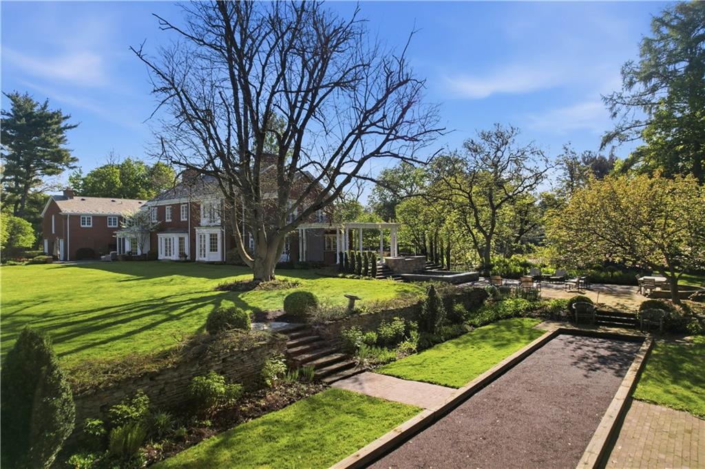 600 Backbone Road Sewickley, PA 15143 - Photo 5 of 50 The long view across the bocce court and landscaped grounds highlights the property’s charm and thoughtful outdoor design. This is a home that lives beautifully both inside and out.