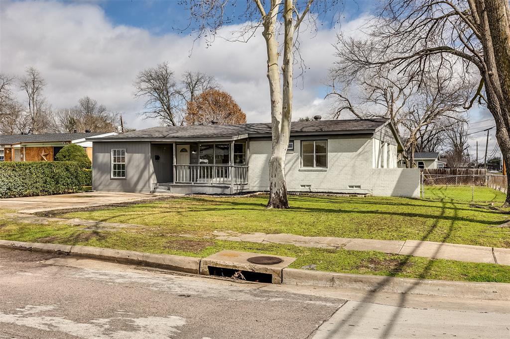a front view of a house with a garden and swimming pool