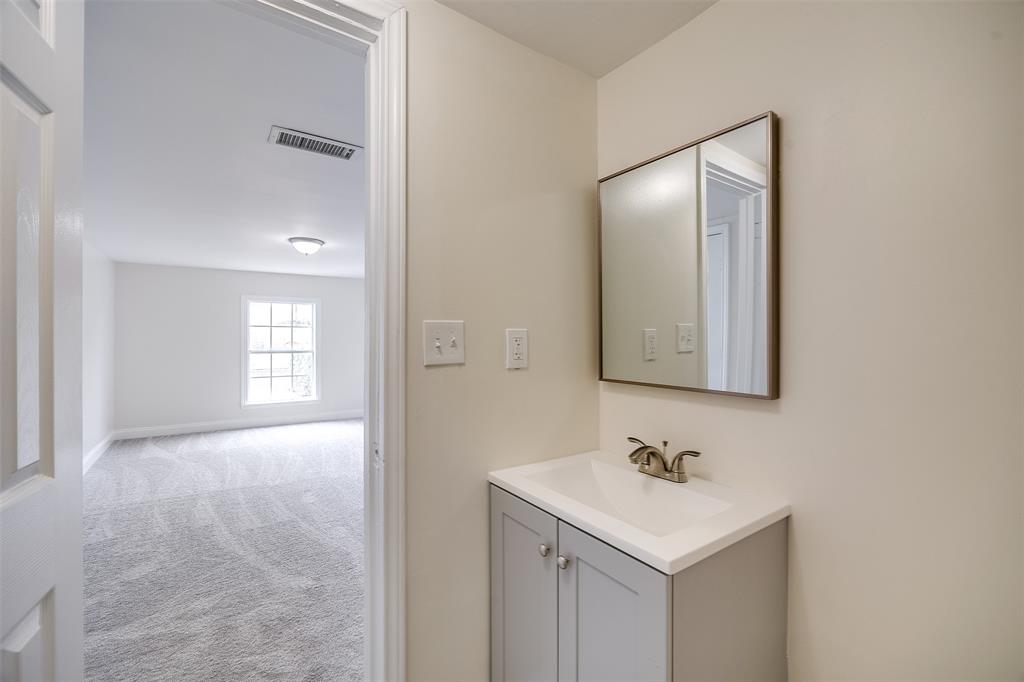3071 Larry Drive Dallas, TX 75228 - Photo 12 of 16 a bathroom with a sink a mirror and a vanity
